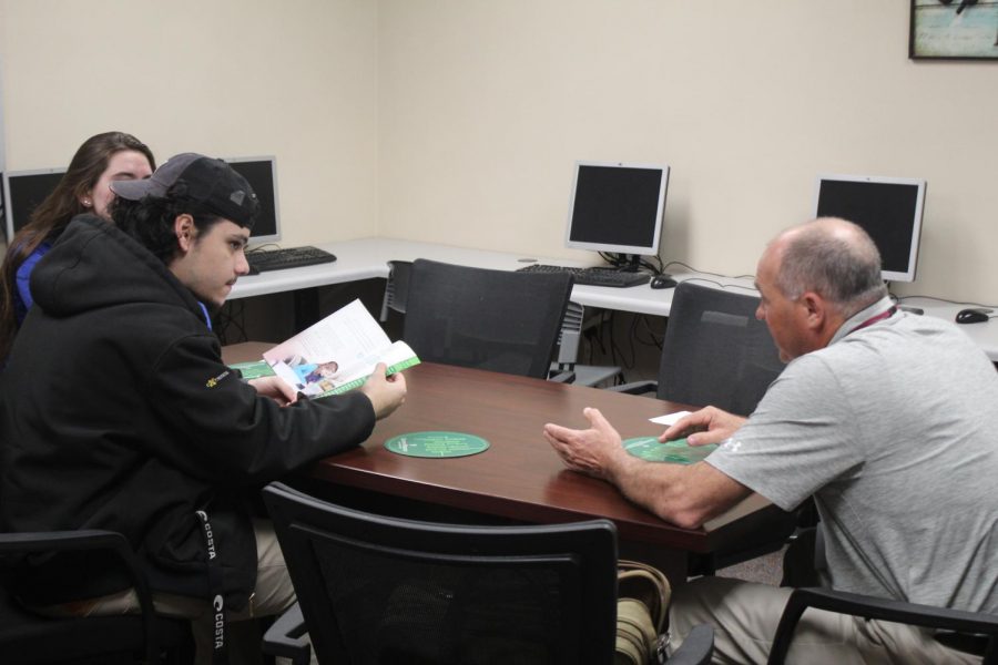 Seniors (left to right) Mallory Dietz and Nicolas Mauser meet with a college rep from Illinois Wesleyan University.